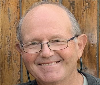 Male with glasses smiling